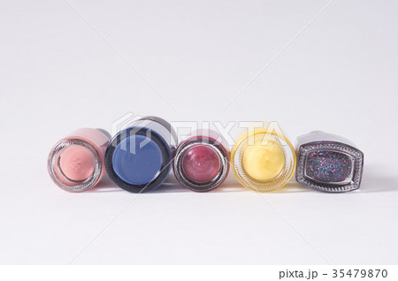 many colored bottles of nail polish in row 35479870