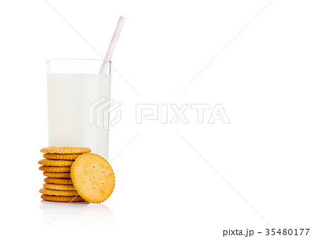 Glass of milk with round cheese crackers on white 35480177