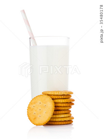 Glass of milk with round cheese crackers on white Glass of milk with round cheese crackers on white 35480178