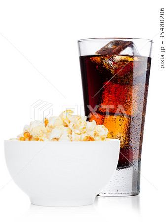 Popcorn salty sweet snack in white bowl with cola Popcorn salty sweet snack in white bowl with cola 35480206