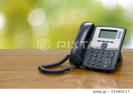 IP telephone on wood table 35480517