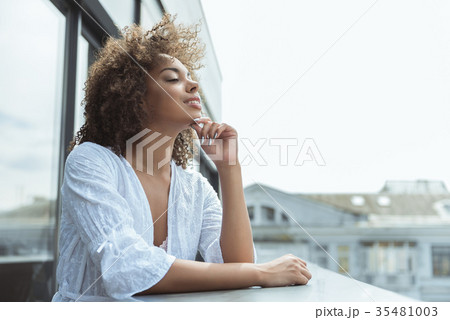 Beaming african woman watching at street 35481003