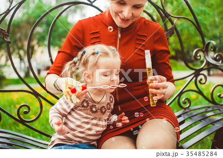 mother and daughter blow bubbles mother and daughter blow bubbles 35485284