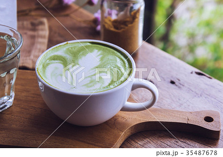 green tea hot drink latte white cup on wood table green tea hot drink latte white cup on wood table 35487678