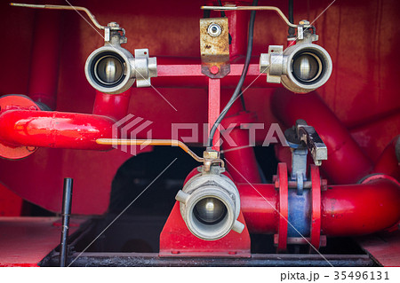 Valve of water pipe on red fire truck Valve of water pipe on red fire truck 35496131