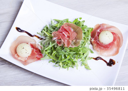 Jamon (ham) with arugula and melons. Jamon (ham) with arugula and melons. 35496811
