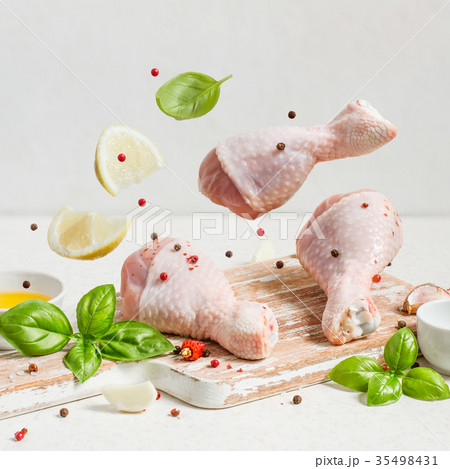 Raw chicken drumstick And spices fly  35498431