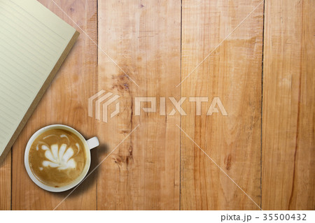 Empty book and hot coffee over wooden board table Empty book and hot coffee over wooden board table 35500432