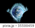 Men's hands holding the planet earth with a blue glow on a black background. 35500459