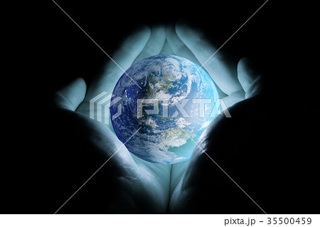 Men's hands holding the planet earth with a blue glow on a black background. Men's hands holding the planet earth with a blue glow on a black background. 35500459
