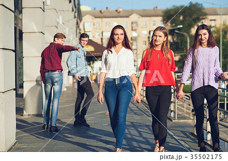 Group of young man flirting with woman in city. Group of young man flirting with woman in city. 35502175