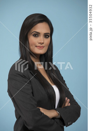 Portrait of young business woman standing with arms crossed Portrait of young business woman standing with arms crossed 35504932