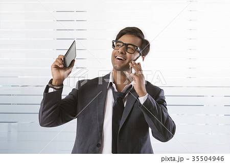 Smiling business executive talking on phone 35504946
