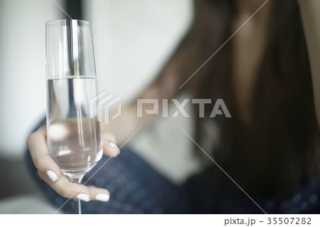 Girl with a glass of champagne at home Girl with a glass of champagne at home 35507282