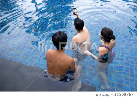 Group of friends taking selfie in swimming pool  35508767