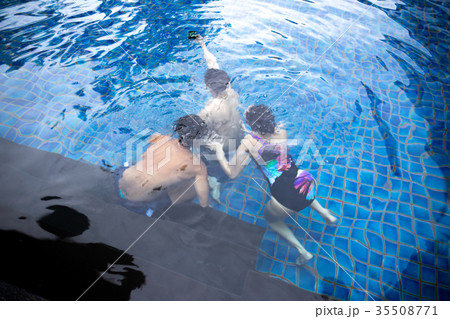 Group of friends taking selfie under the water  35508771