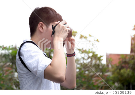 Man tourist taking photo with compact camera  35509139