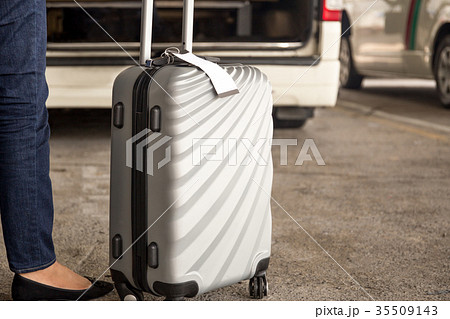 Woman tourist with luggage waiting for taxi Woman tourist with luggage waiting for taxi 35509143