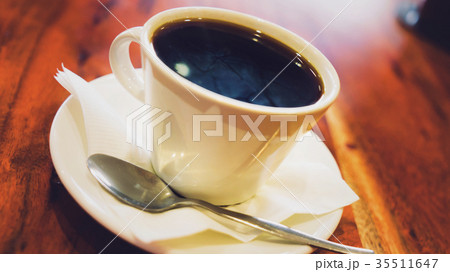 Black coffee in white cup on the brown wooden 35511647
