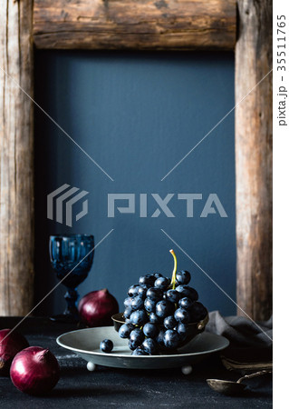 Black grapes on vintage silver tray still life 35511765