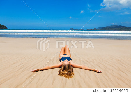 Happy woman in bikini enjoy sunbathing on beach Happy woman in bikini enjoy sunbathing on beach 35514695