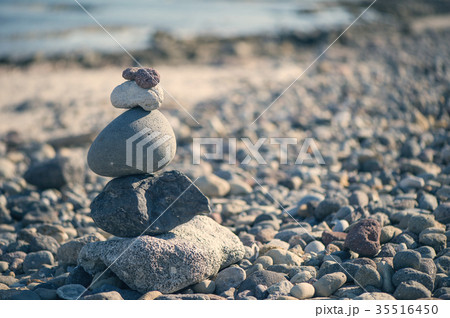 Pyramid of stones on the beach against the sea  35516450