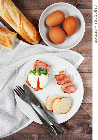 Breakfast with poached egg with bacon 35516837