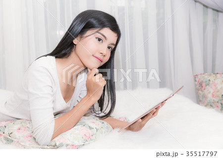 Beautiful woman holding tablet on living room. 35517797