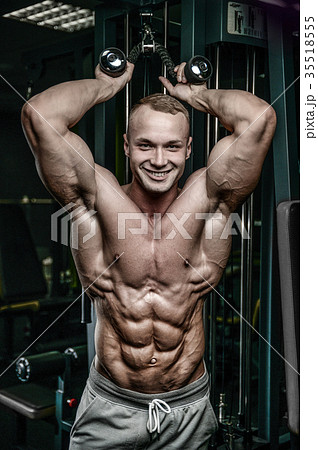 Attractive model young man training in gym 35518555