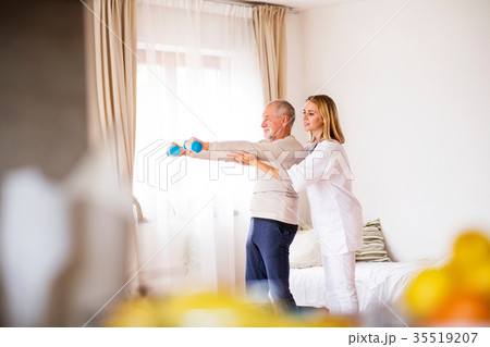 Health visitor and senior man during home visit. 35519207