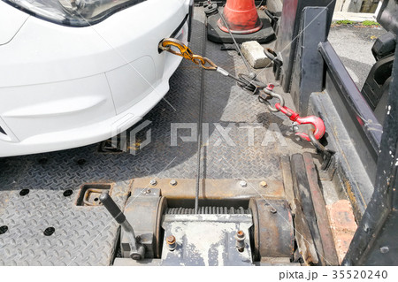Car towed onto flatbed tow truck with chain Car towed onto flatbed tow truck with chain 35520240