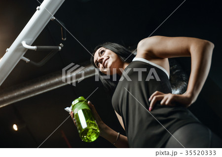 Sexy athletic young girl takes sport nutrition Sexy athletic young girl takes sport nutrition 35520333