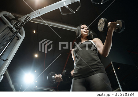 Sexy athletic young girl working out in gym Sexy athletic young girl working out in gym 35520334