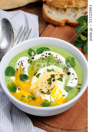 Pea puree soup with poached egg and peppermint Pea puree soup with poached egg and peppermint 35520961