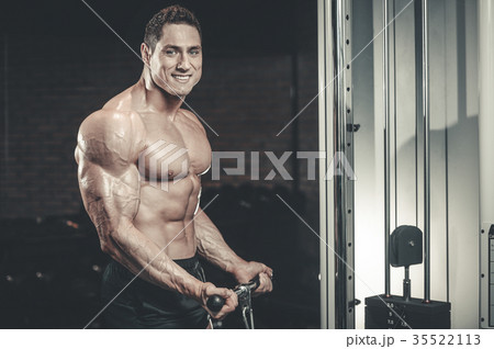 Brutal Caucasian bodybuilder working out in gym 35522113