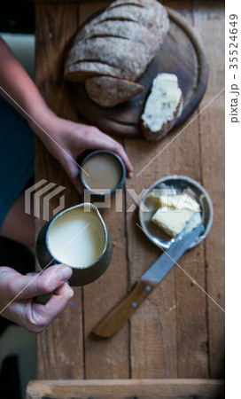 Top view woman has breakfast adds milk to coffee Top view woman has breakfast adds milk to coffee 35524649