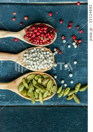 Close up three wooden spoons with colorful spices Close up three wooden spoons with colorful spices 35524692
