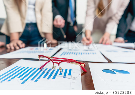 Close-up of eyeglasses on a printed bar chart 35528288