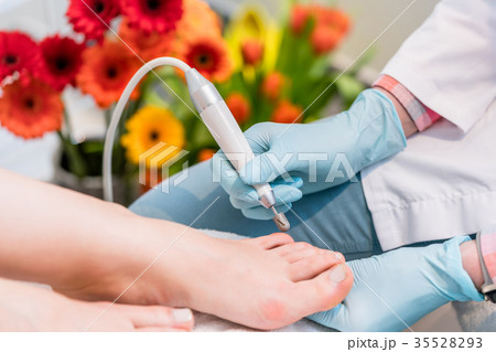 Close-up of the hands of a pedicurist wearing 35528293