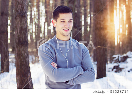 Sports man doing boxing exercise in forest. Winter Sports man doing boxing exercise in forest. Winter 35528714