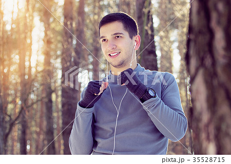 Sports man doing boxing exercise in forest. Winter Sports man doing boxing exercise in forest. Winter 35528715