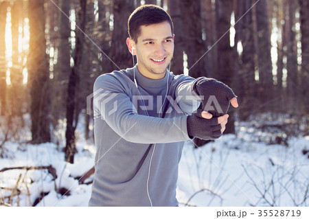 Sports man doing boxing exercise in forest. Winter 35528719
