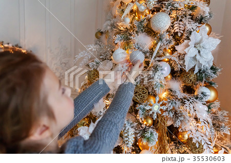 Young girl decorating Christmas tree 35530603