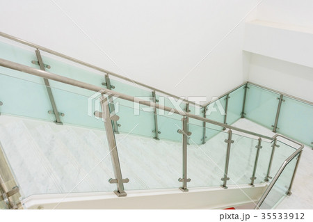 white marble stairs with steel and glass railing  35533912