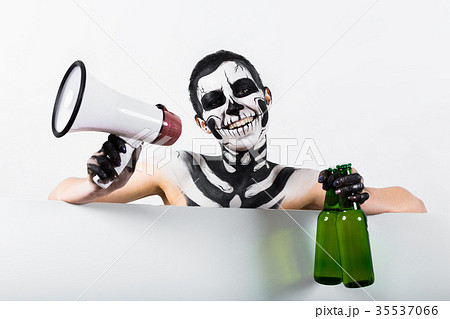 Attractive girl with skeleton makeup hold bottle Attractive girl with skeleton makeup hold bottle 35537066