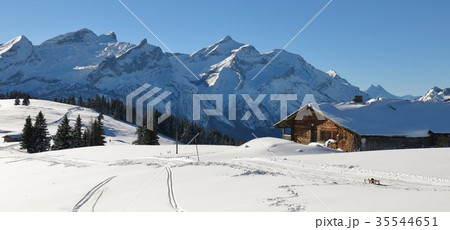 Old timber hut and snow covered mountain Range.  35544651