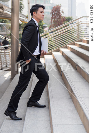 confident businessman stepping up to success 35545380