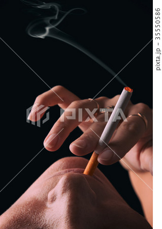 Smoking girl on a black background 35550586