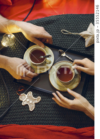 Two tea cups and for hands. Top view Two tea cups and for hands. Top view 35552146