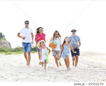 Group of young people with kids on the beech Group of young people with kids on the beech 35552270
